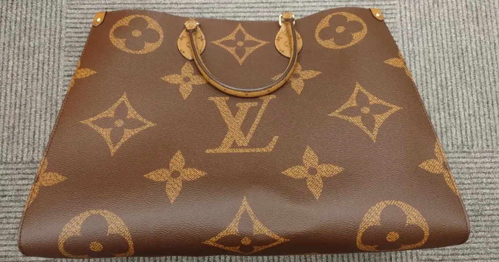 大きなロゴ模様が入ったルイ・ヴィトンの茶色いトートバッグ